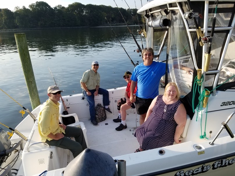 From left to right: Trevor Ibsen, Shawn Cushing, Bill Morris, Parran Wilkerson (boat captain), and Carol Morris relax before launching on their morning fishing adventure. 
