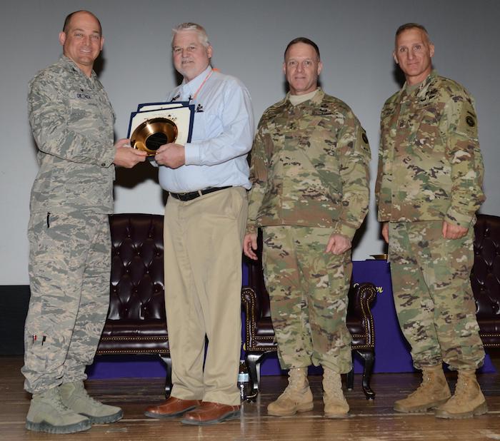 Damond is receiving the award from Col. Dietrich III, commander of the JBER/673 ABW. The photo was taken by Airman 1st Class Christopher R. Morales