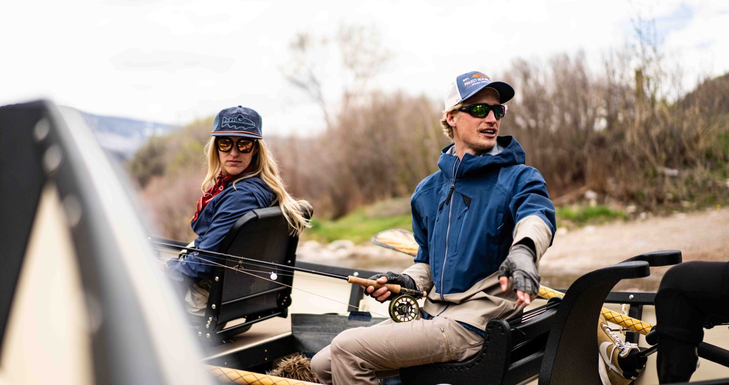 Two Anglers Rig Up In A Drift Boat