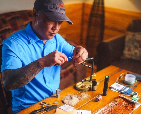 Man tying fly ties